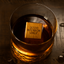 Oak Ice Cube with the engraving "Good Bourbon Only" sitting inside of a glass of whiskey.