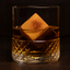 Rocks glass Glass containing a large ice cube on a dark background