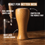 A light brown oak beer pilsner glass with a tapered shape and a thick base, shown on a wooden bar counter with a blurred background featuring a beer tap and an American flag.