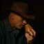 Man wearing a cowboy hat and holding a nosing glass made from oak wood
